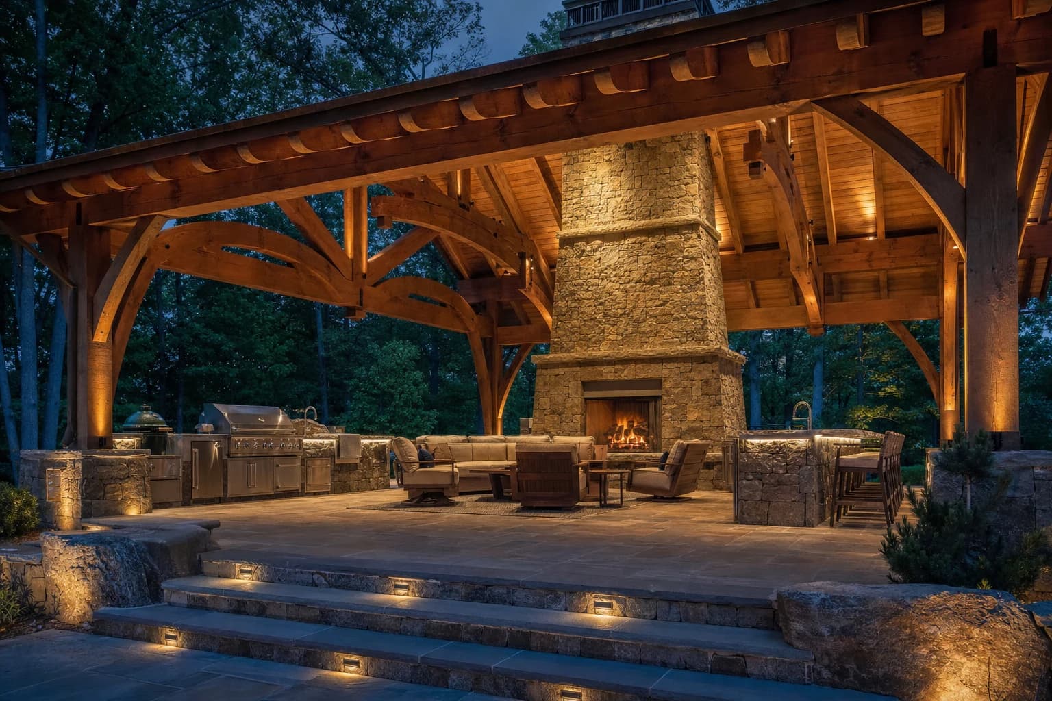 Massive outdoor living pavilion with a soaring stone fireplace and outdoor kitchen on a Great Falls, Virginia estate