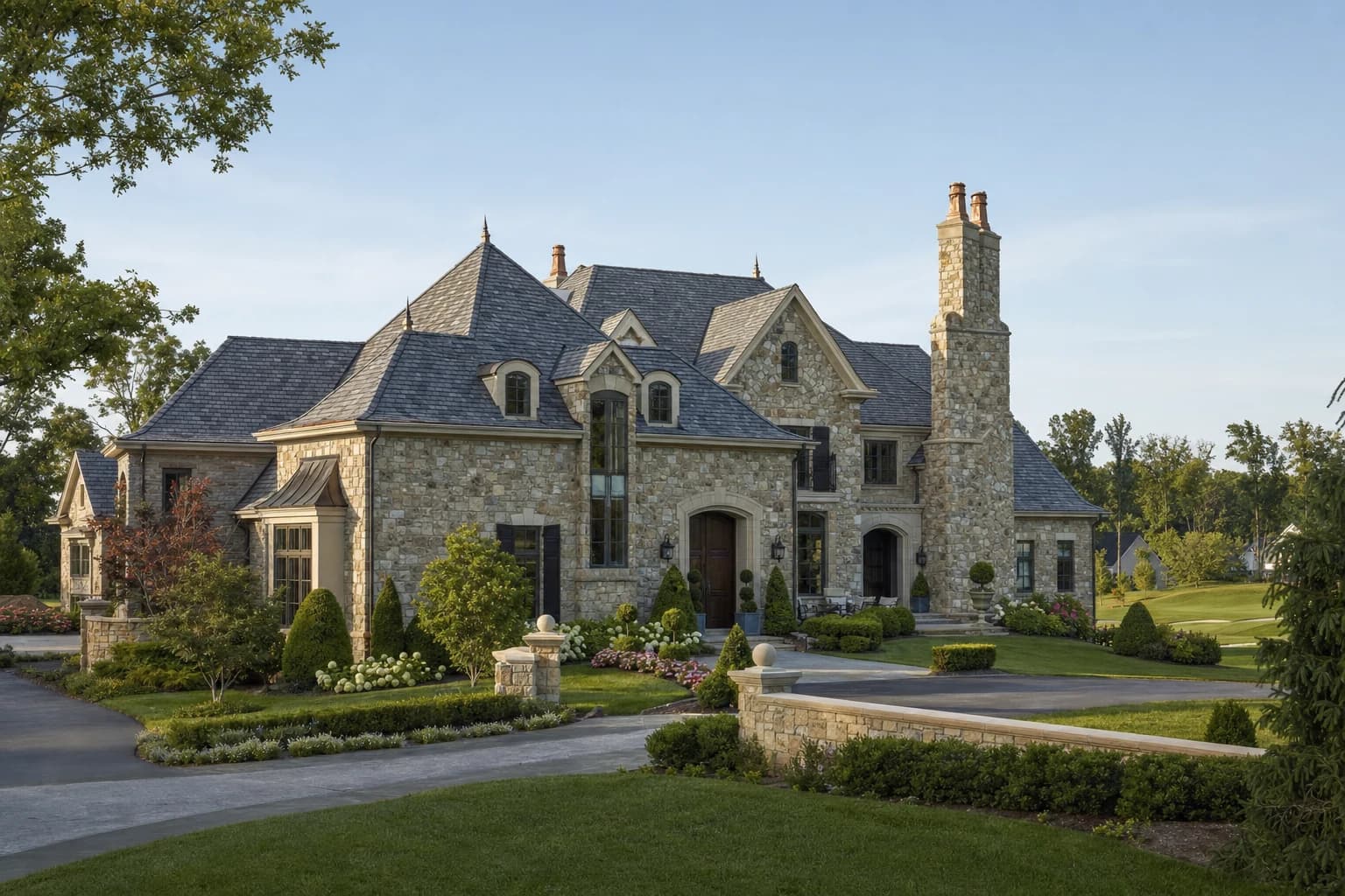 Luxury French Country custom estate sitting on a manicured golf-course lot in Aldie, Virginia, with a slate roof and stone facade